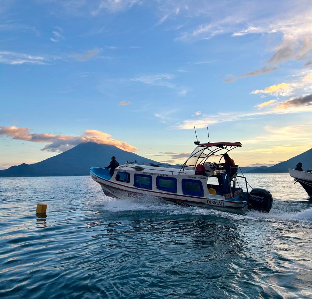 Boat crossing Lake Atitlán at sunset, Guatemala