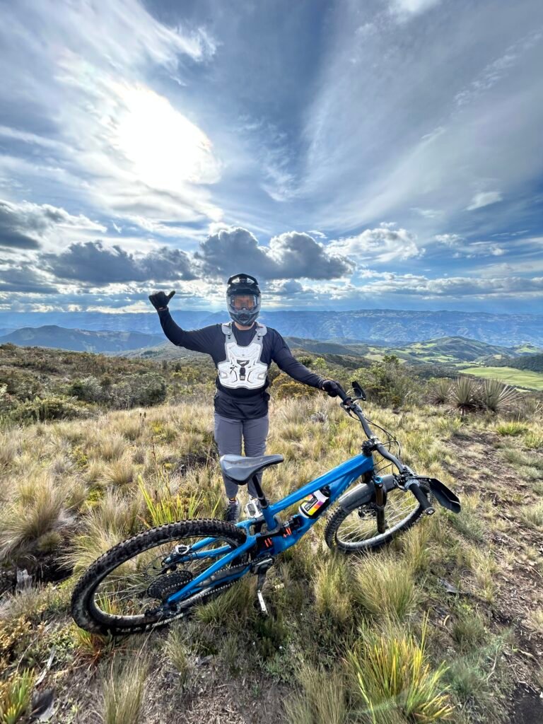 Rider with a downhill bike on an Andean ridge
