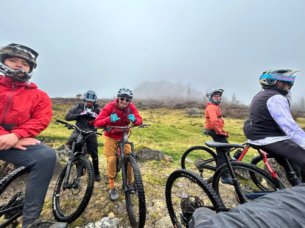 Group of mountain bikers resting on a misty Andean plateau