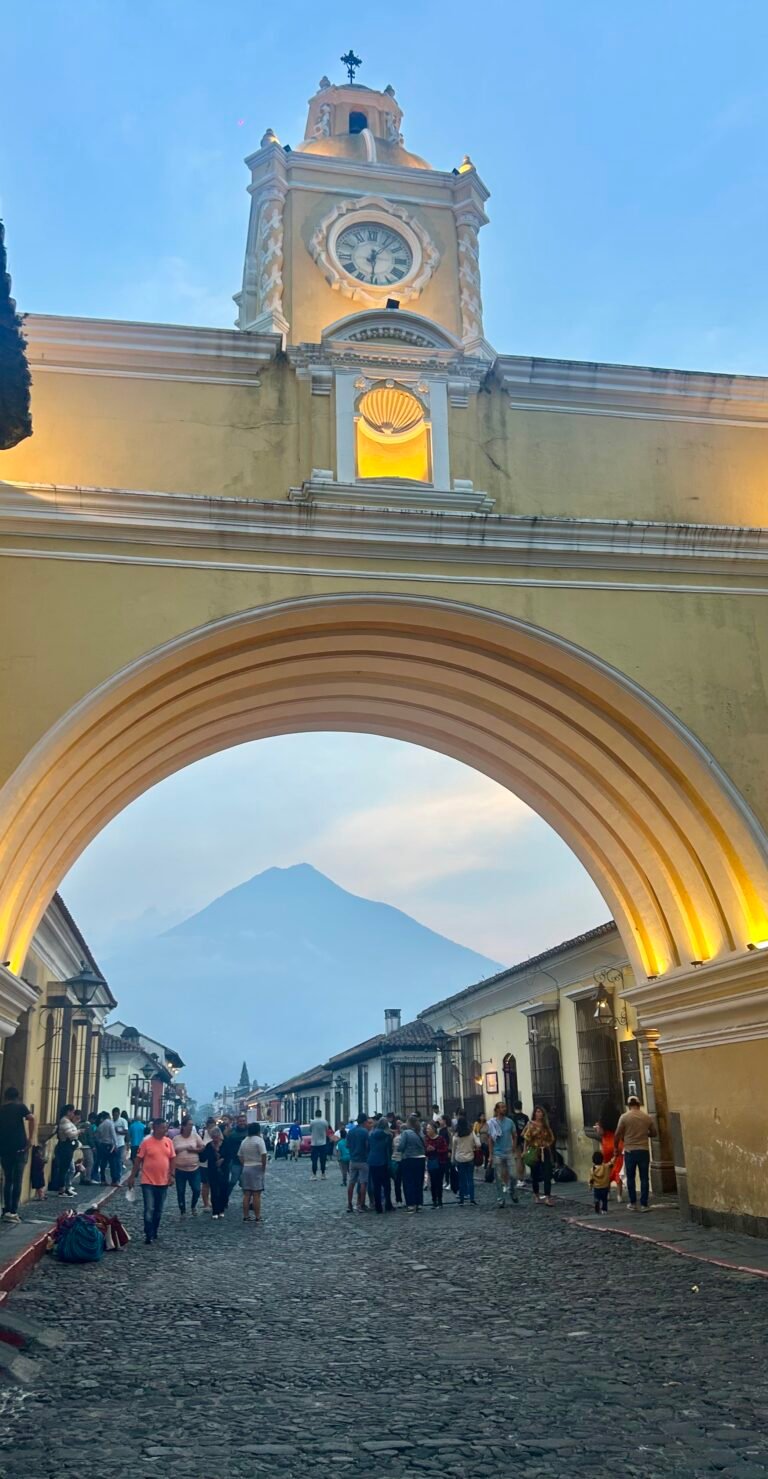 Santa Catalina Arch in Antigua, Guatemala, with a volcano in the background