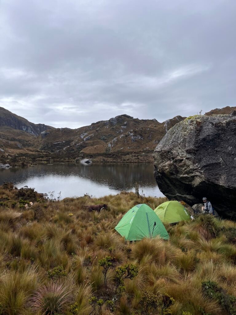 Tents pitched beside a highland lake in the Andes