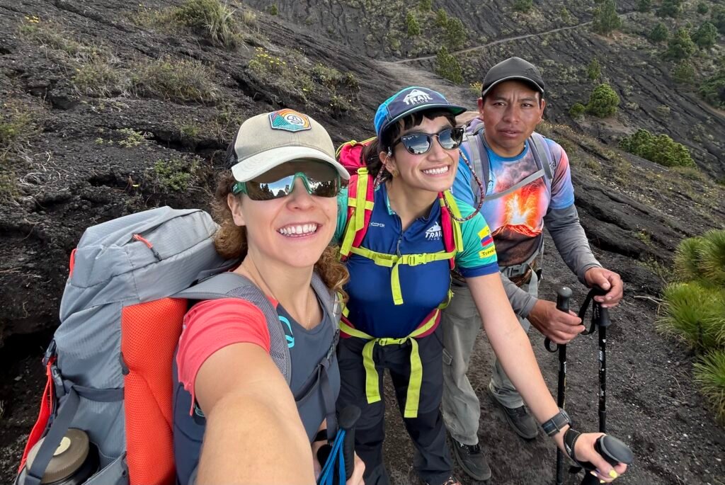Hikers smiling with their local guide on a volcano trail